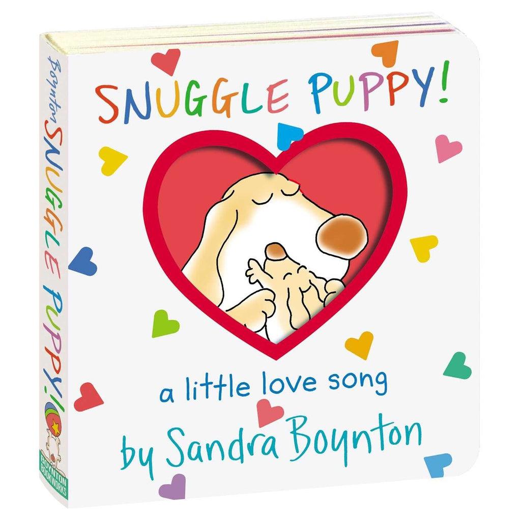 Image of the cover of the Snuggle Puppy book. It has a heart-shaped cutout to the next page which has a picture of a larger dog hugging a small puppy.