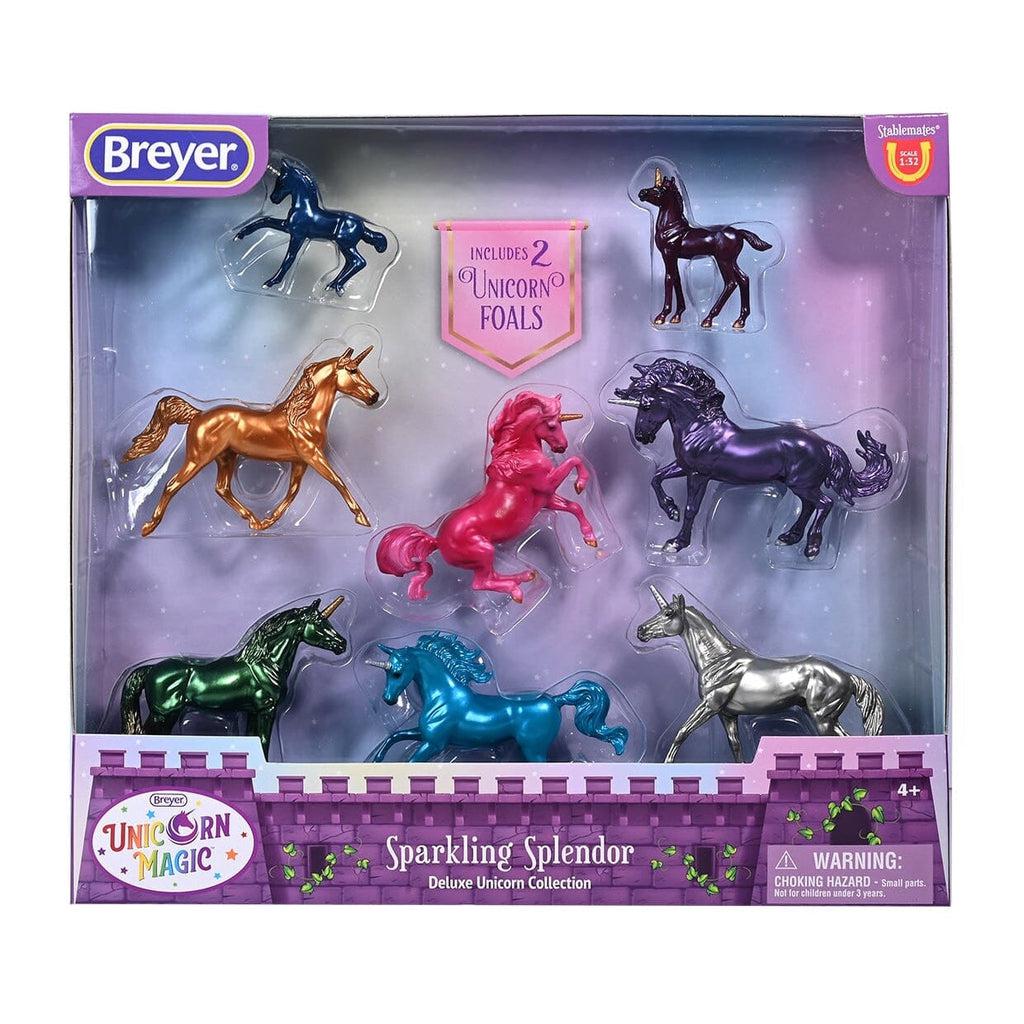 Image of the packaging for the Sparkling Splendor Deluxe Unicorn figurine set. Most of the front is see through so you can see the small figurines inside.