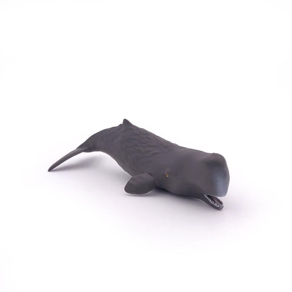 Image of the Sperm Whale Calf figurine. It is a dark grey sea creature with a small mouth and large tail.