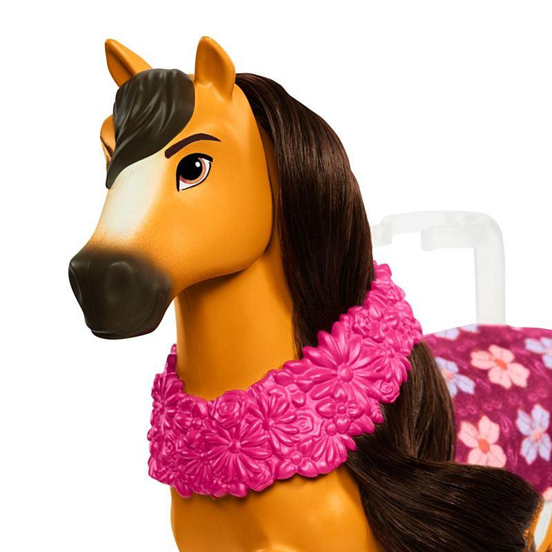 Spirit is wearing a pink flower garland and a pink flower blanket on his flank.
