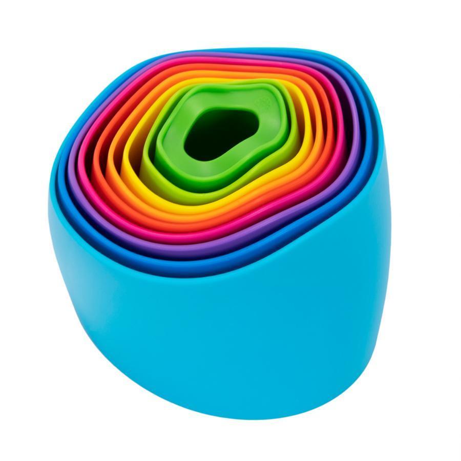 Image of the collapsed toy outside of the packaging. There are many multicolored layers starting with green in the center and going out in a rainbow to the blue edge.