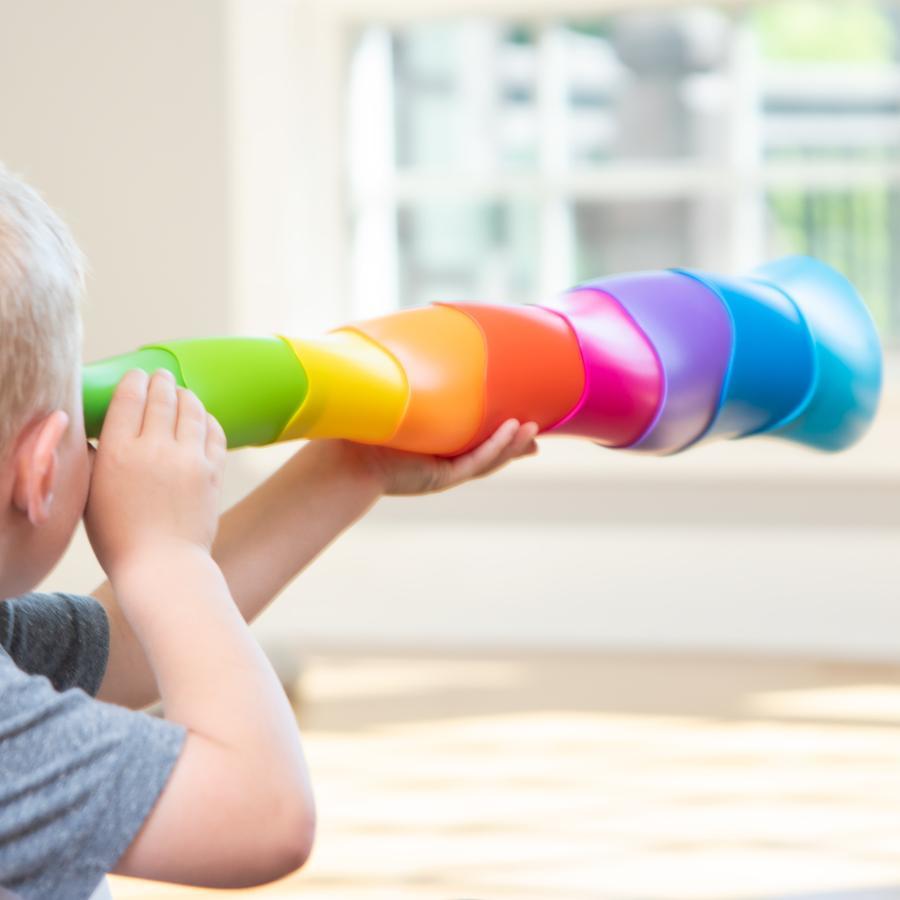 Scene of a little boy using the extended toy as a telescope/spyglass.