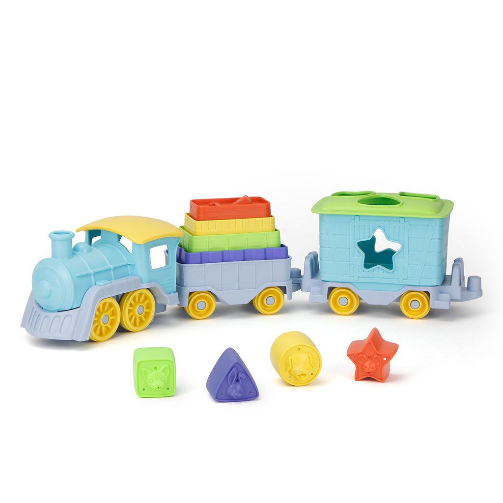 Image of the toy outside of the packaging. It is a train that comes in three parts, the engine, and two storage cars. The two cars in the back hold different stacking blocks and it also has a place where you can sort come differently colored and shaped blocks.