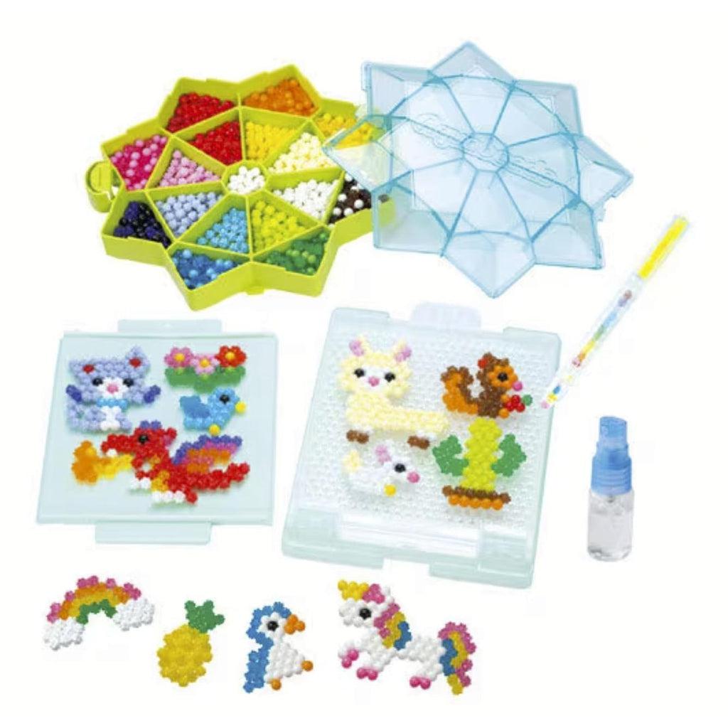 Image of the contents of the craft kit. It comes with many different colors of star beads, creation tablets, and a water sprayer.