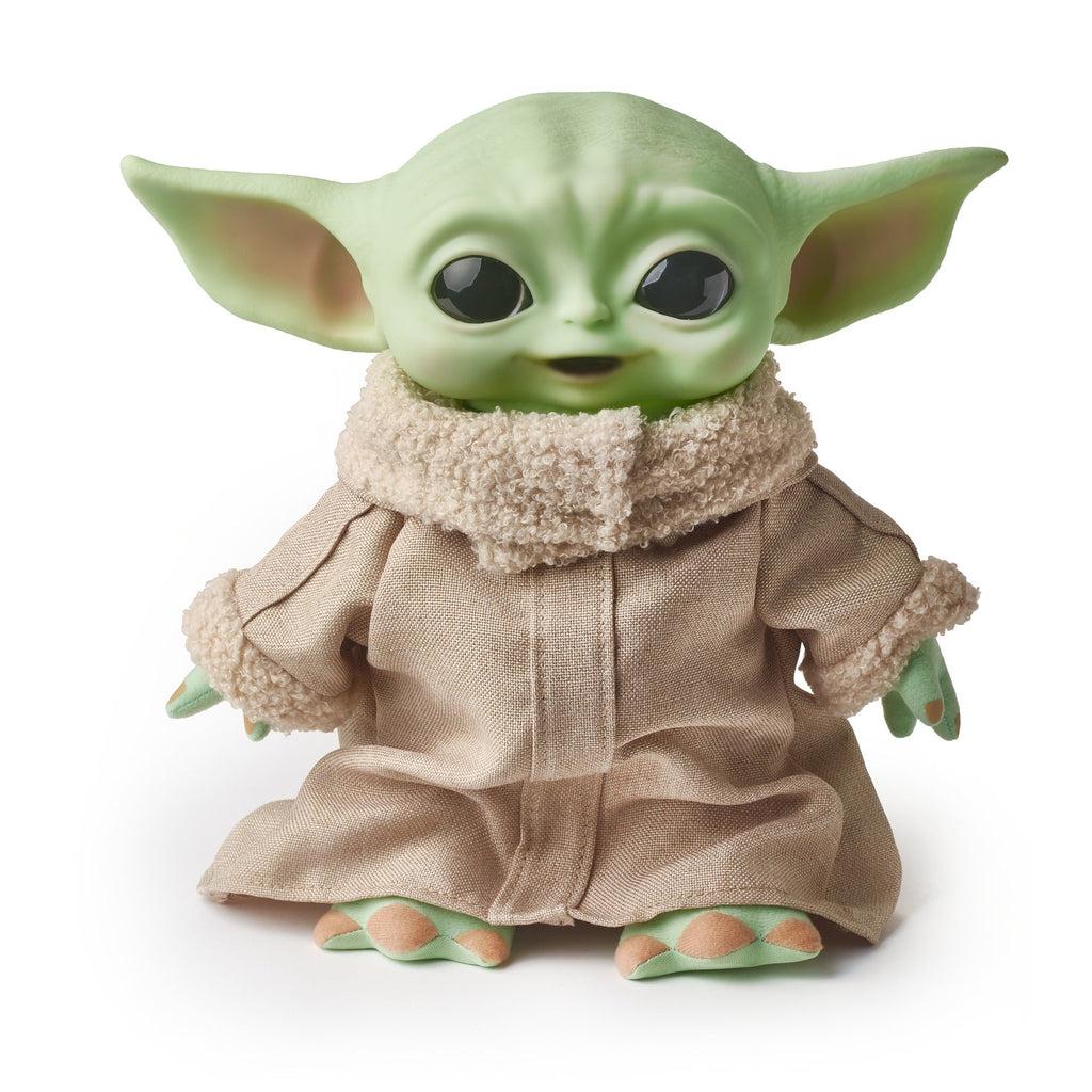 Image of the toy outside of the packaging. The Child looks just like he does in The Mandalorian TV show. He has light green skin, big eyes, and is wearing a potato sack looking outfit.