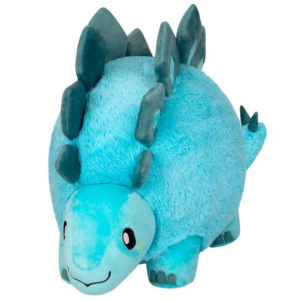 A plush toy resembling a Squishable Stegosaurus with teal plates and a happy expression.