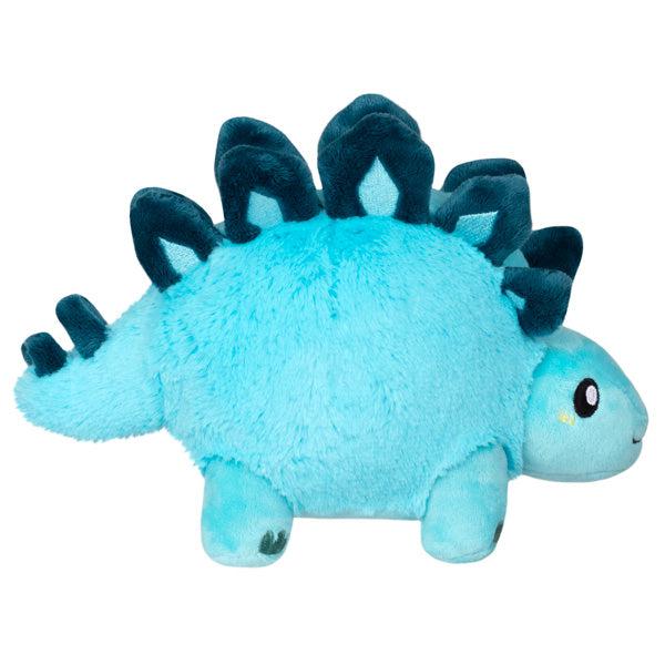 Side view of the plush. Shows that its head pokes out of the front and its tail is sticking out of the back.