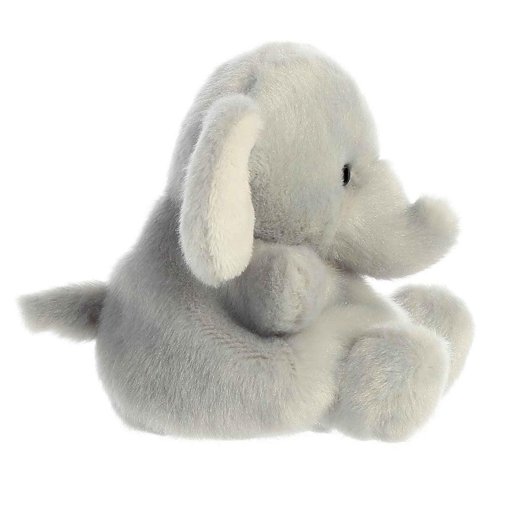 Side view of the elephant plush. From this angle you can see the long trunk that curls up at the end and the small tail in the back.