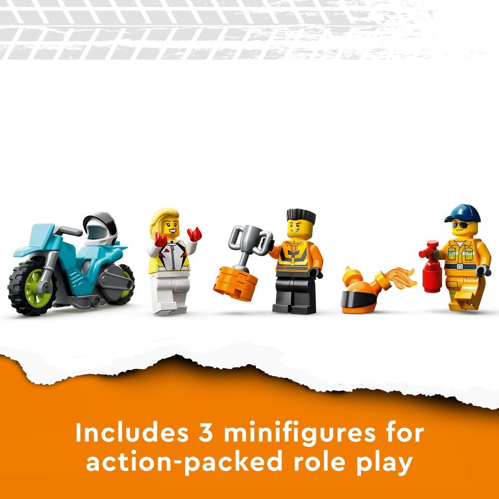 Close up of the three included minifigures. One is a girl in a white riding outfit, one is a man in an orange riding outfit, and the last one is a fire tech holding a fire extinguisher.