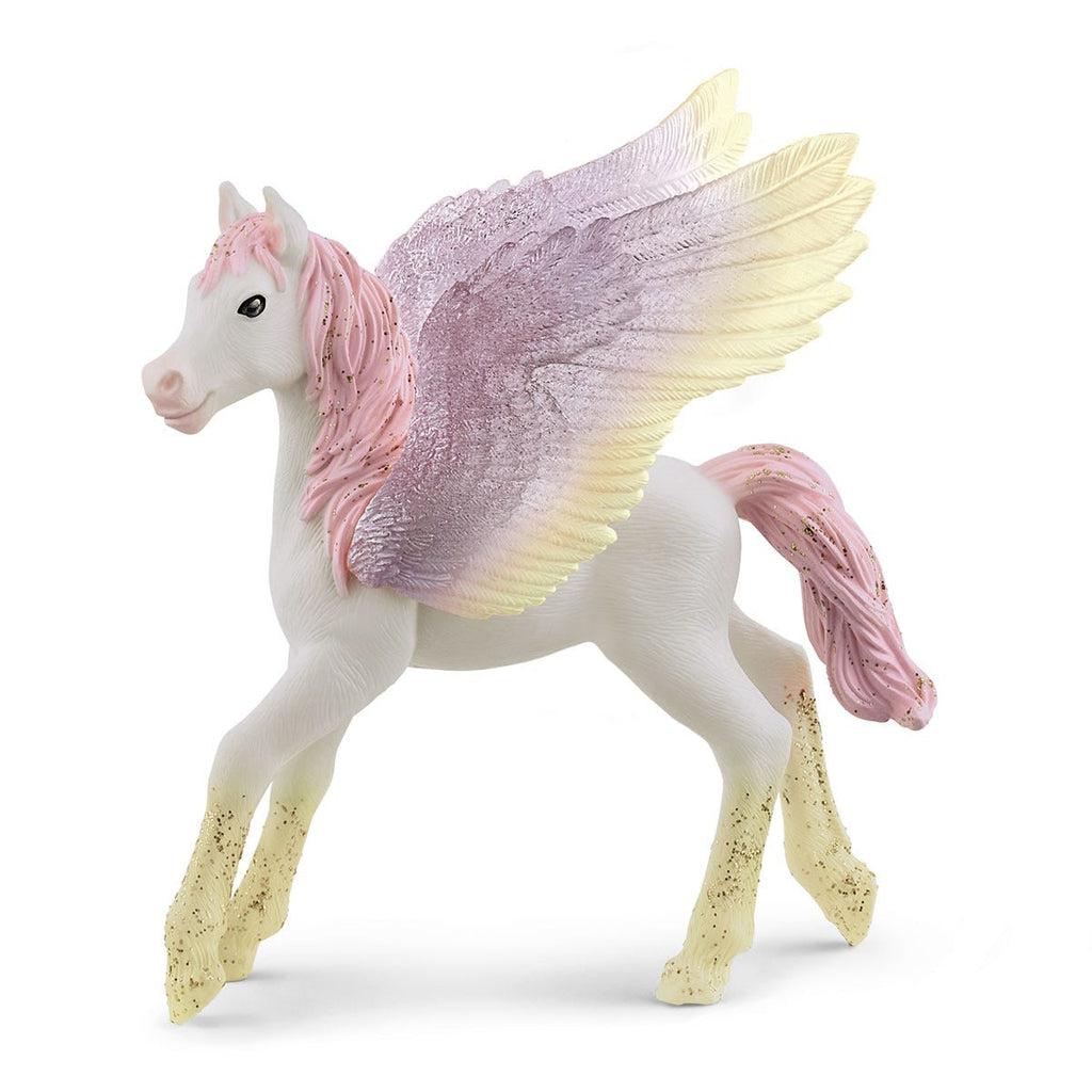 Image of the Sunrise Pegasus Foal figurine. It is a white horse with a bubblegum pink glittery mane and tail. Her wings are translucent purple with golden tips. Her feet are also glittery golden.