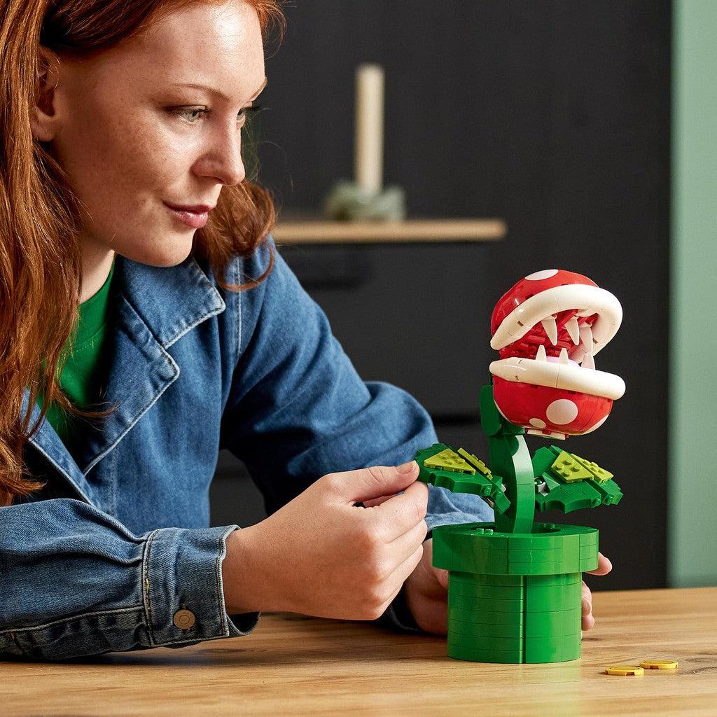 image shows a woman constructing the leaves  on Piranha plant