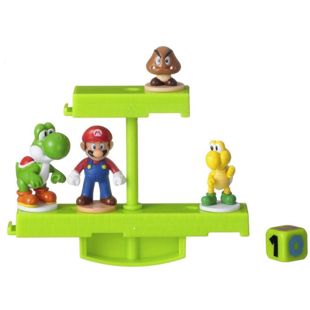 Image of the overworld balancing game. It is green and it comes with Mario, Yoshi, a goomba, and a koopa troopa.