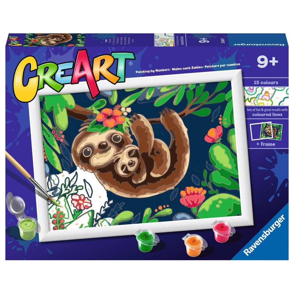 This image shows the box of the "sweet" sloths hanging in a tree. there is a mother and her baby in the tree smiling while holding onto a thin branch. the painting comes with a frame