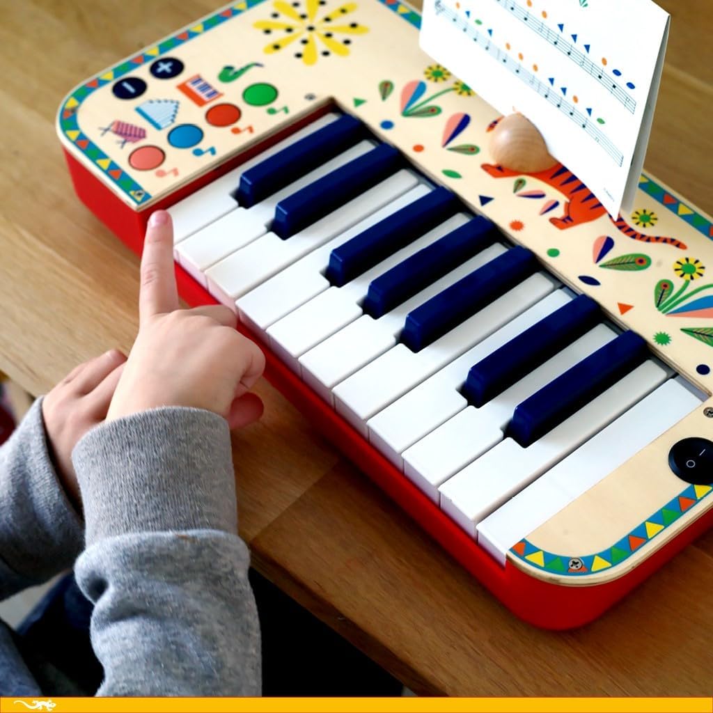 this image shows a young child playing the keyboard, there is music clipped to the top on the synth