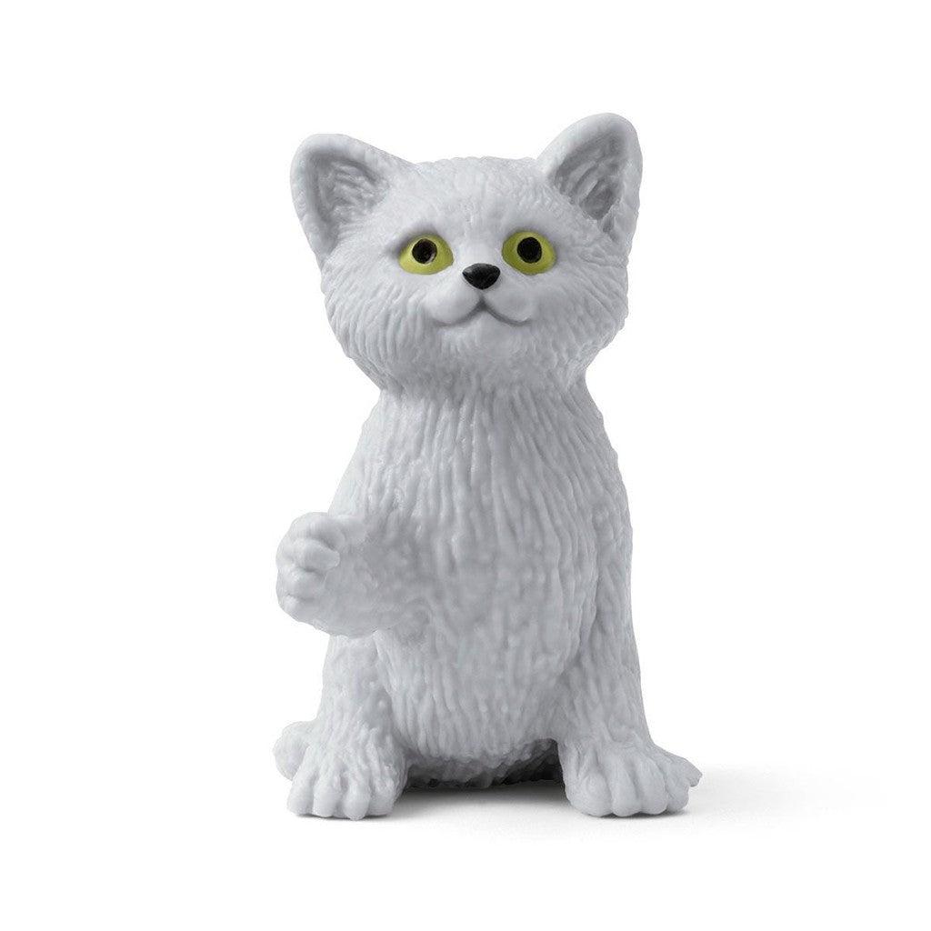 a close up of the cat figurine is shown. It's a small white cat with yellow eyes