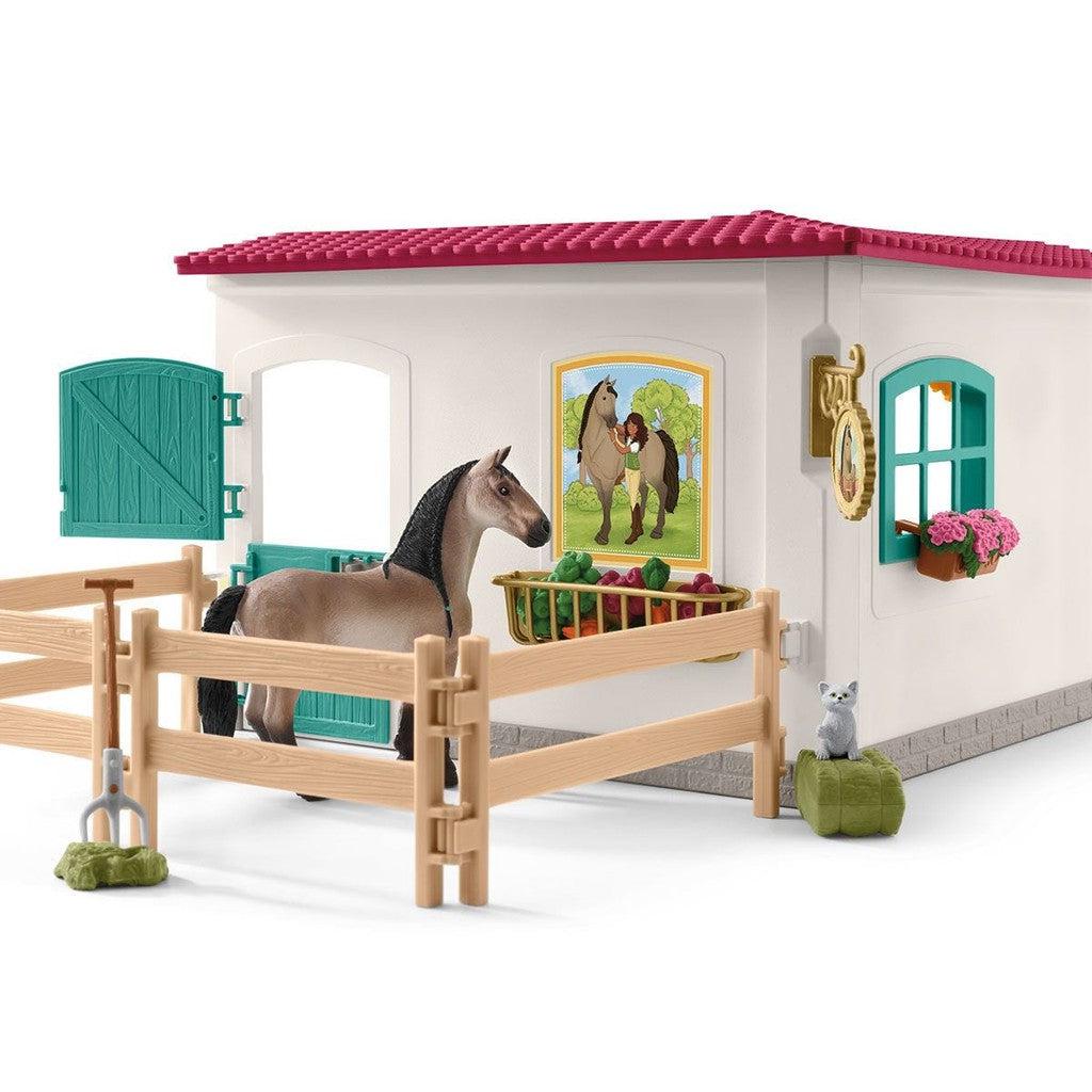 The horse figurine is shown in the fenced area outside the building