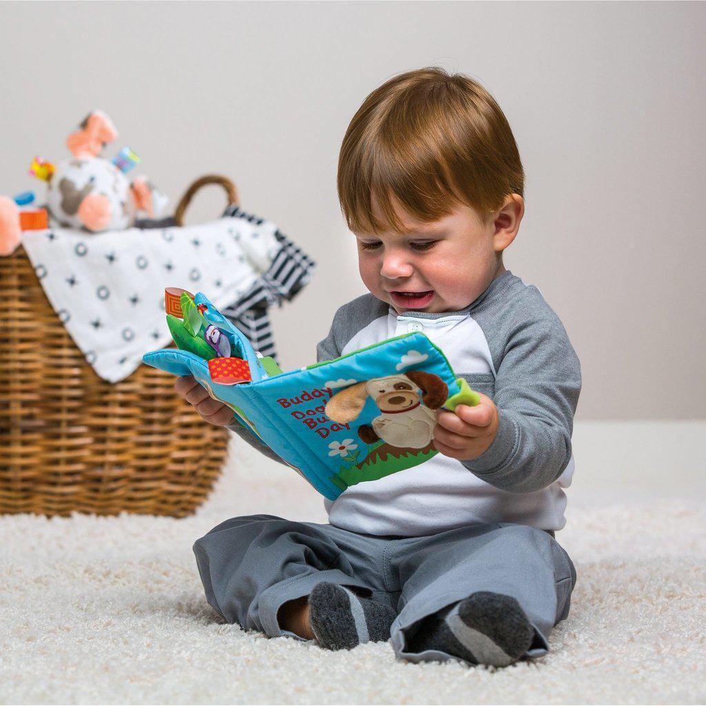 Scene of a little boy smiling while holding the book.