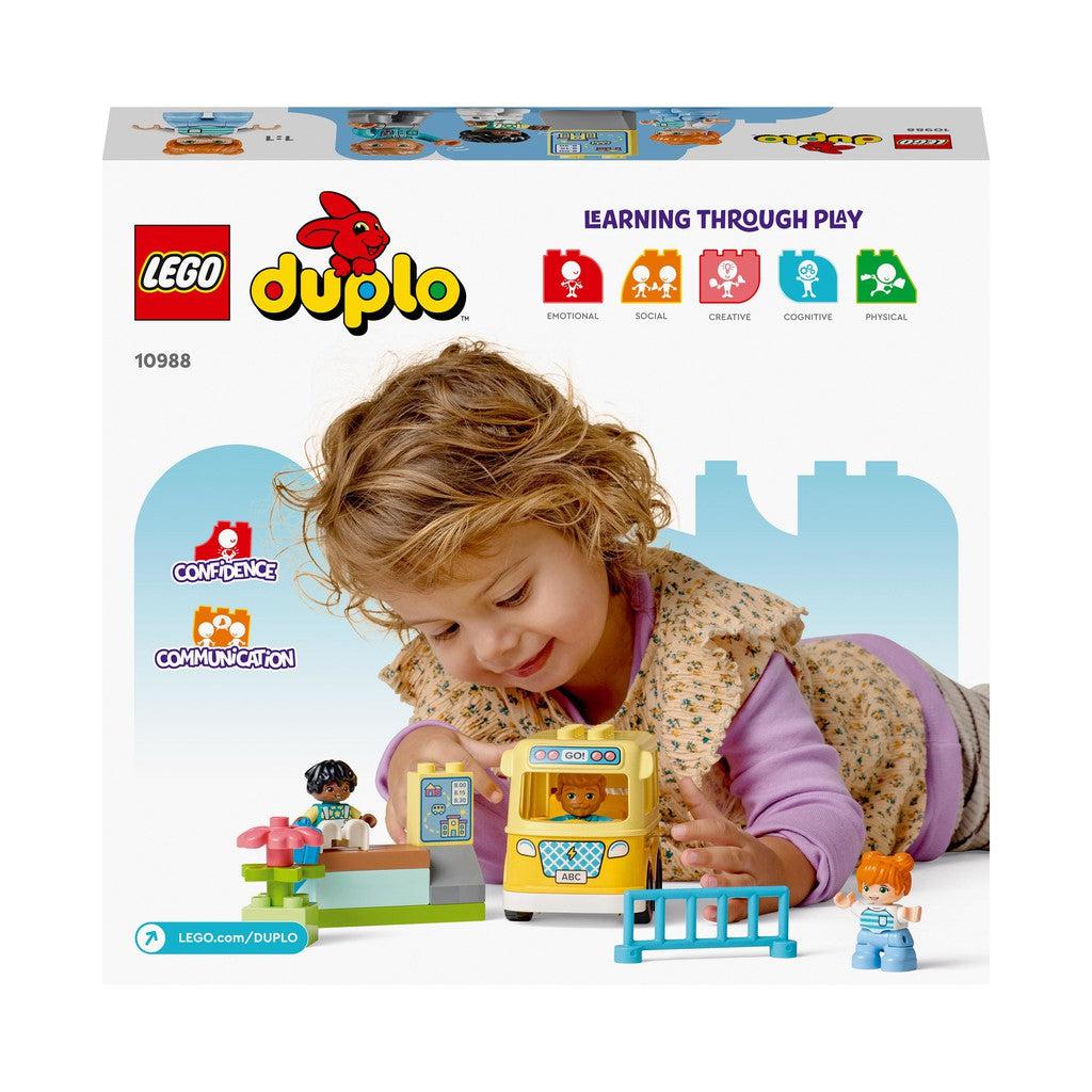 the back of the box shows a toddler playing with duplo