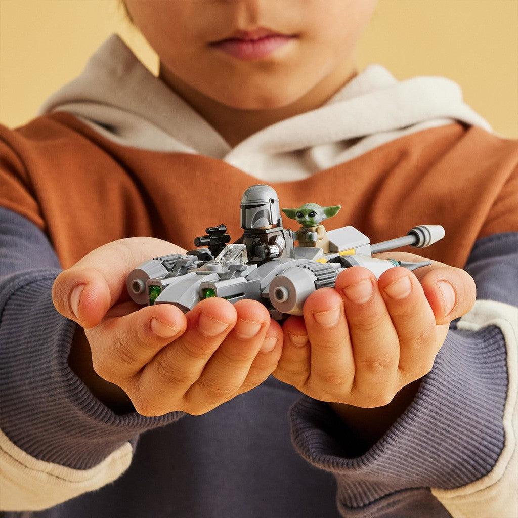 image shows a kid holding the N-1 starfighter