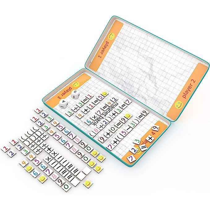 Image of the inside of the game tin. There are sides for up to four different players. The background looks like crinkled graph paper and there are lots of included number and symbol magnets.