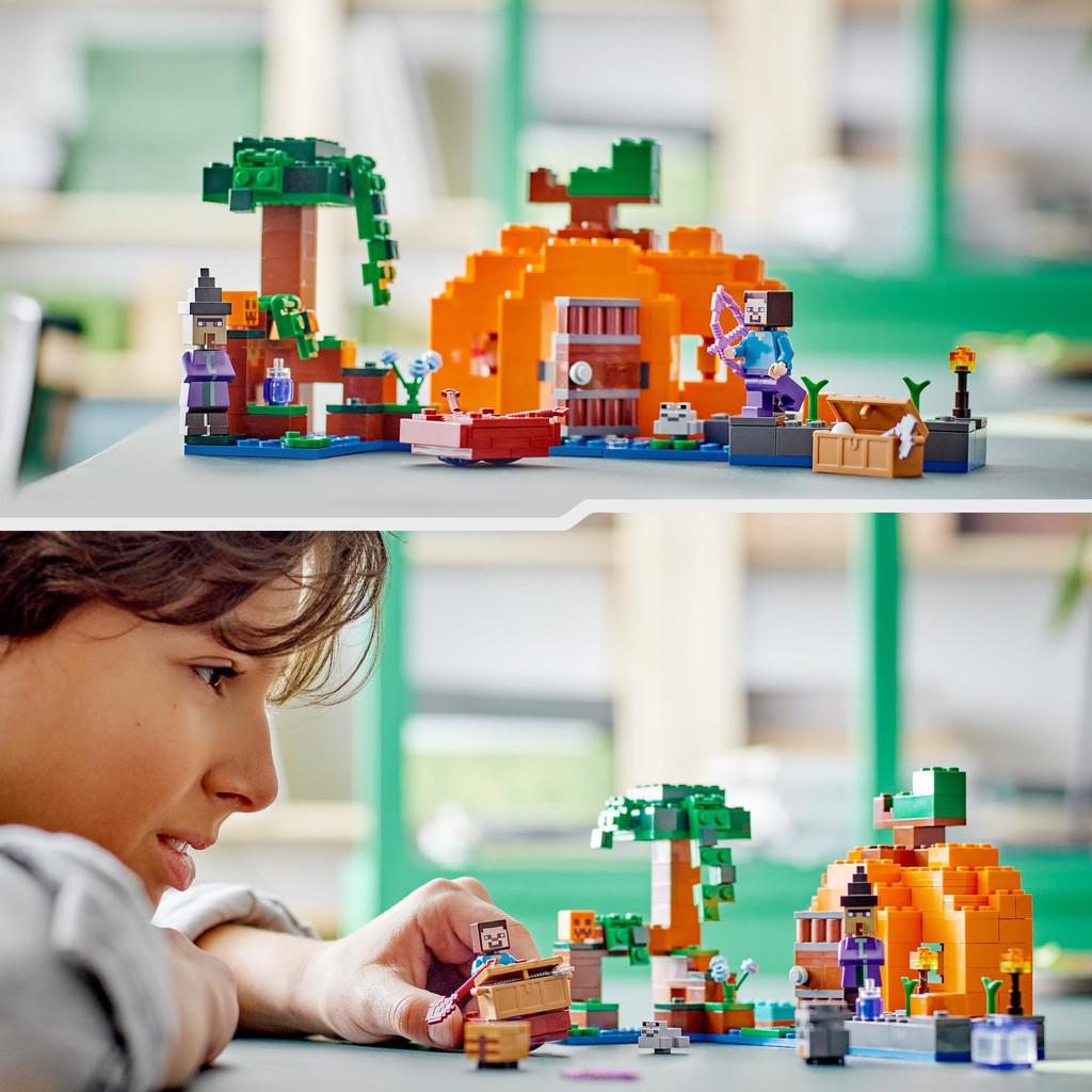 image shows a kid playing with the LEGO house and minifigures