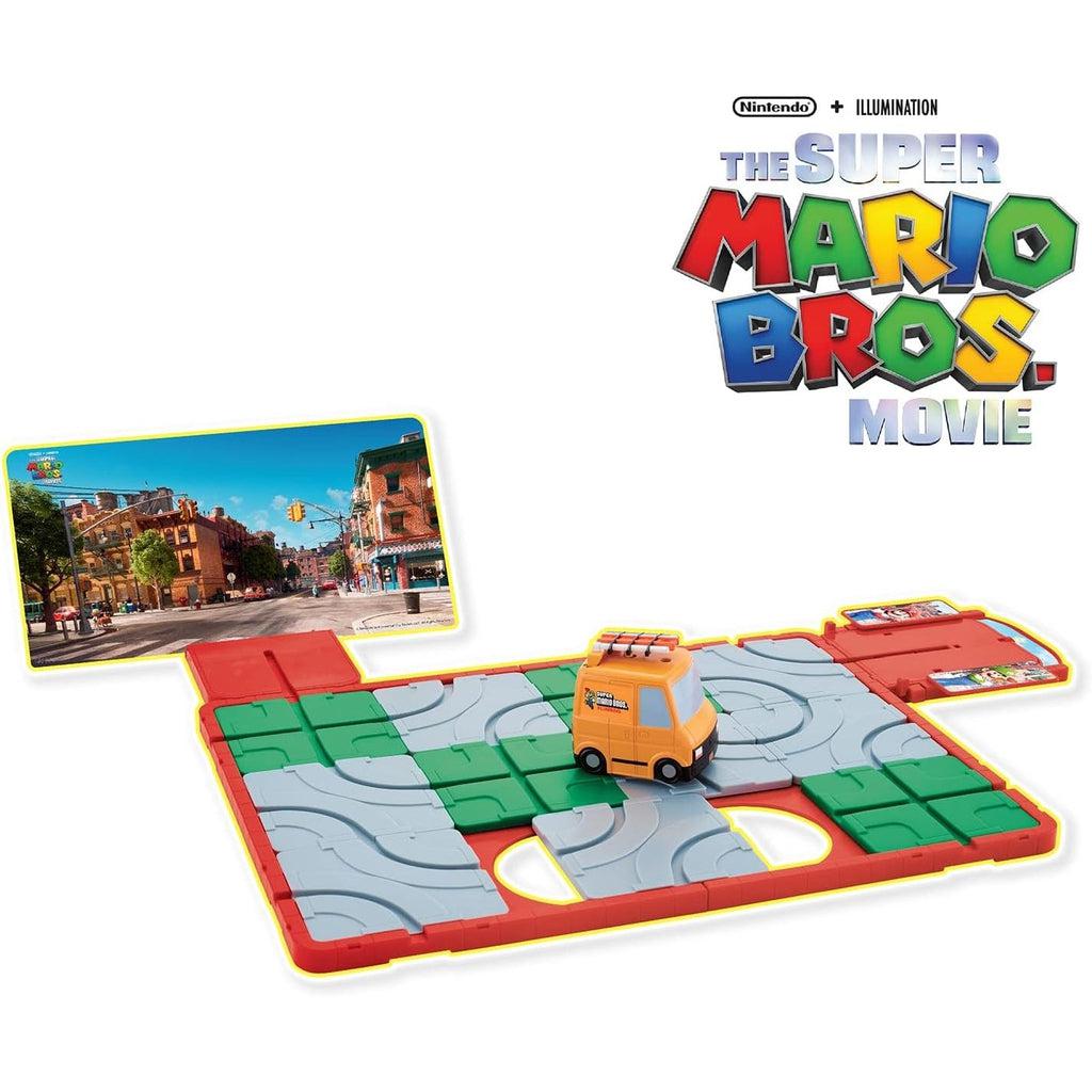 Image of the game outside of the packaging. It is a sliding puzzle board with tracks that the toy Super Mario plumming van. The goal is to get the van from the start to the finish in Brooklyn.