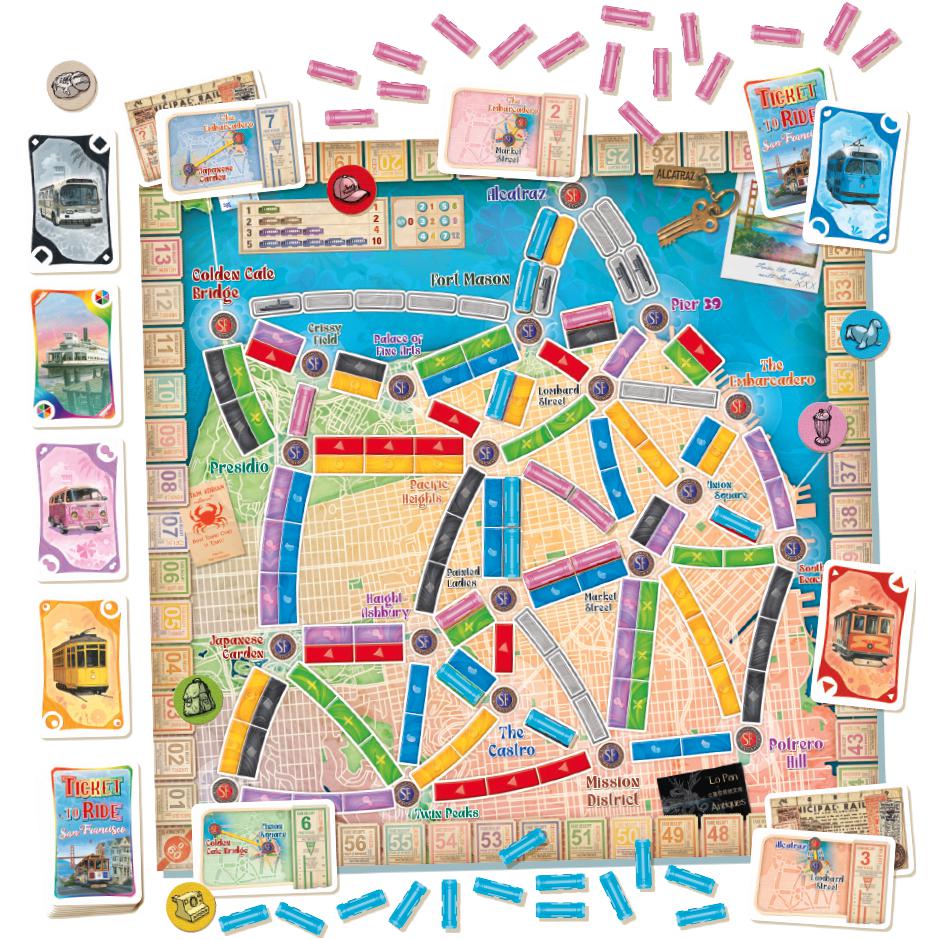 Image of the fully put-together game board. It is a smaller board of the San Francisco area with the names of each location in varying colors. The train cards are themed for the game to include trolley cars and VW vans.