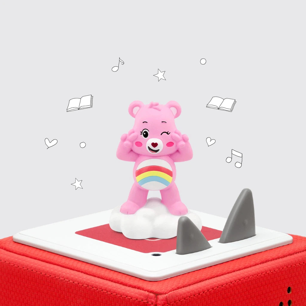 A cheer bear, one of the care bears leaders, tonie figure on top of a red tonie box