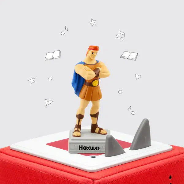 The hercules tonie on a toniebox. The tonie figure is hercules from the disney movie, a large brawny man with red hair and greek clothing standing on a pedestal with his name on it