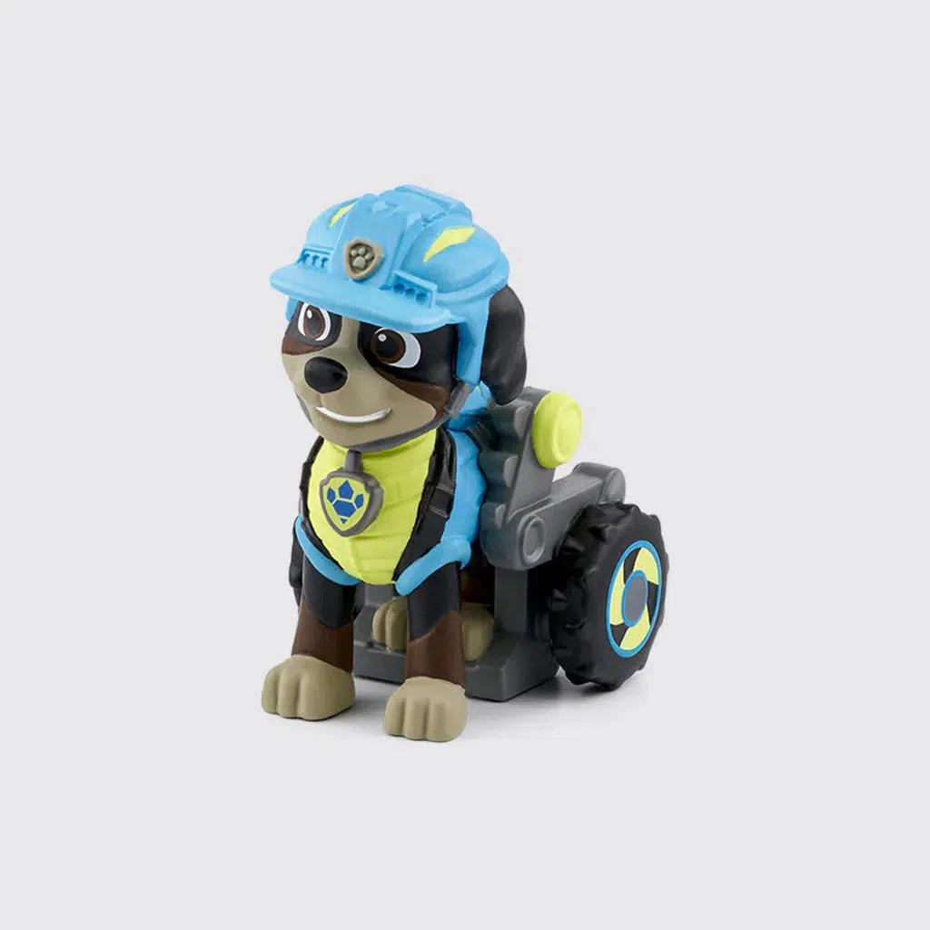 Tonie figure is a dog with a wheelchair with big off road tires for it's back legs.  It's wearing a safety helmet and a vest