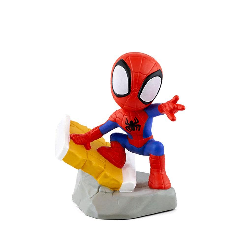tonie figure is spiderman. He's standing on top of a rock and a broken segment of a brick wall