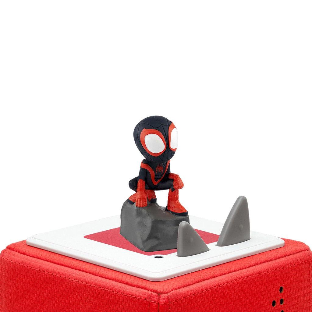 tonie figure is shown on top of a toniebox