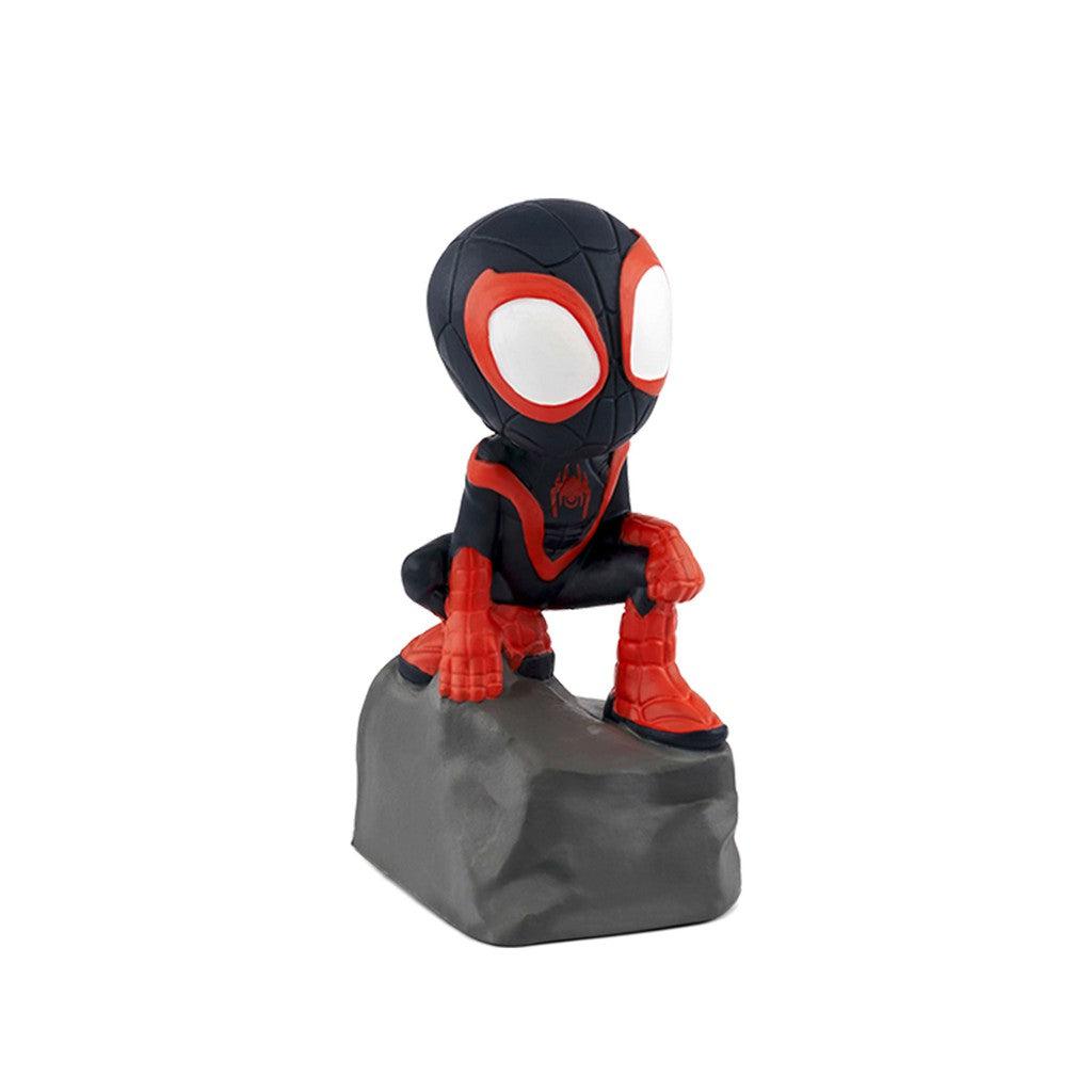 Tonie figure is miles morales' spiderman "Spin" from Spidey and his amazing friends, crouched on top of a rock