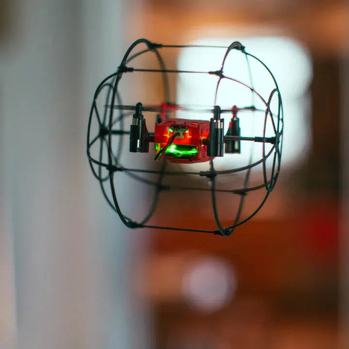 Shows the drone in action, flying. When on, it has a green light.