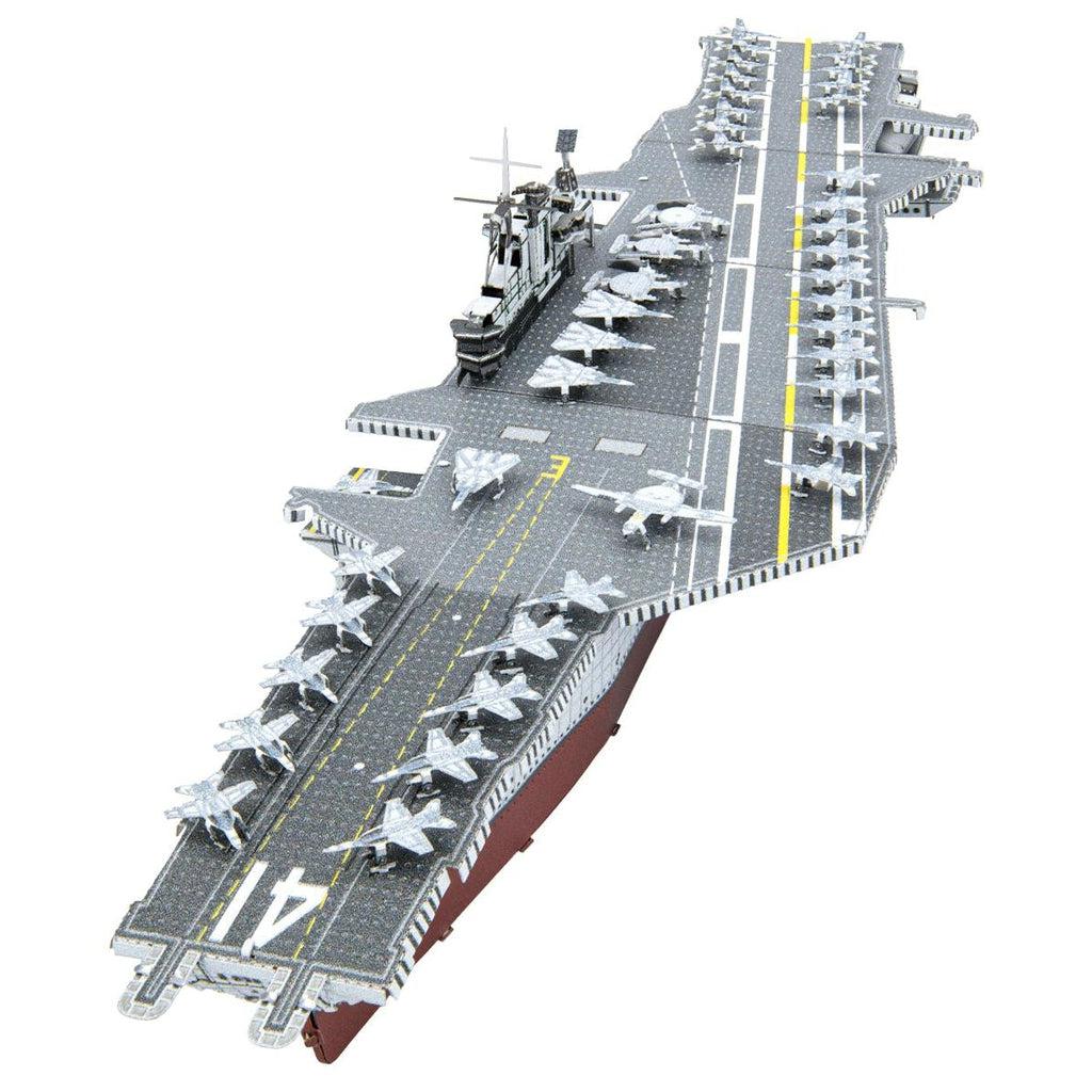 Image of the USS Midway model. It is a mainly metallic silver aircraft carrier (complete with tiny jets on top) with some white and yellow painted lines as well as a red bottom.