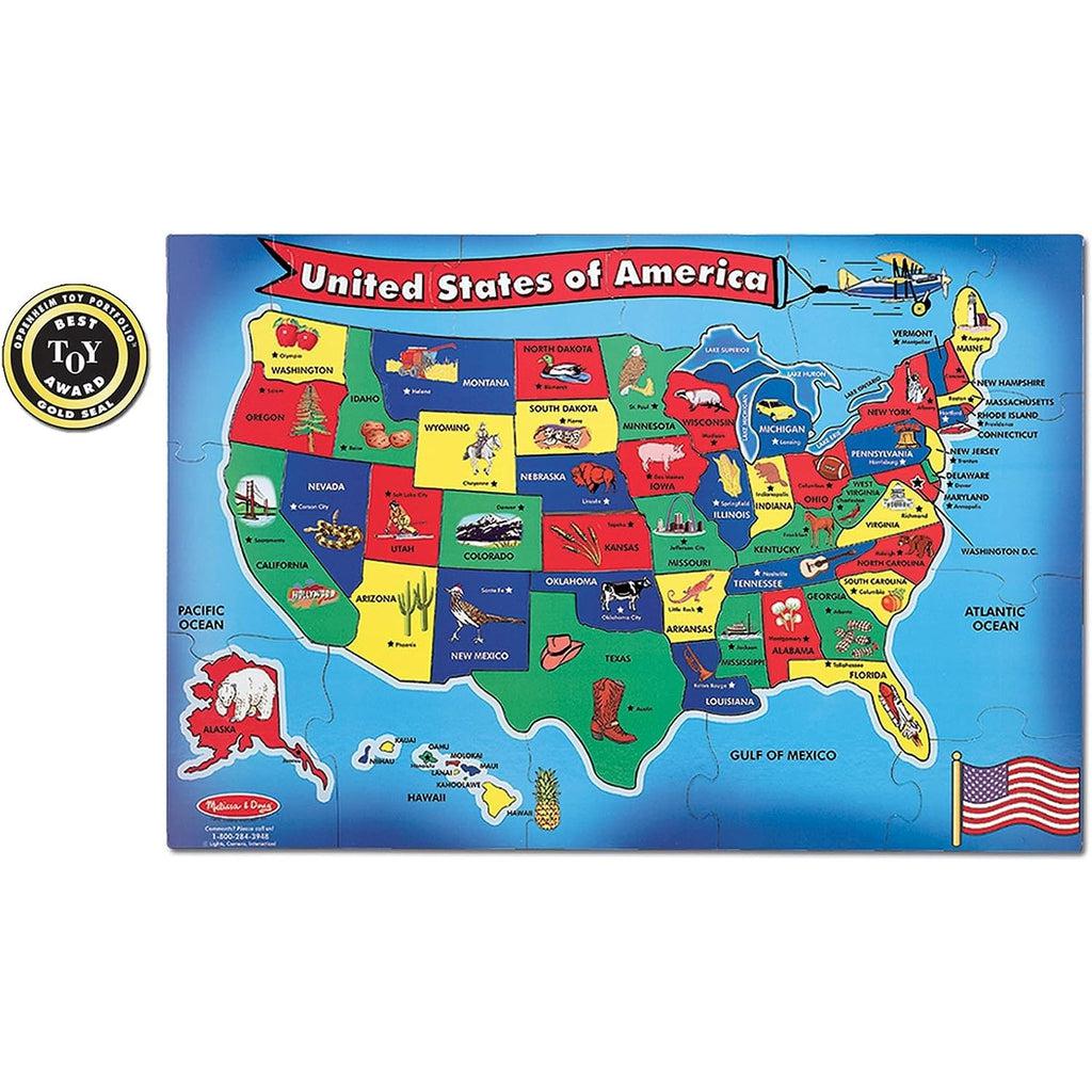 Image of the finished floor puzzle. It is a map of the US with each state being a different color. They are all labeled with its name and its capital. There are also generally a picture of an object to represent the state it is in.