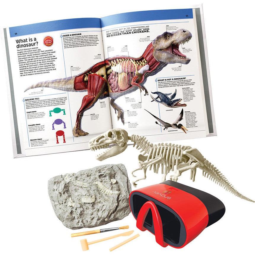 this image shows the book, displaying the anatomy of a t-rex, a model of some fossils, and a dig kit to role play unearthing dinosaur fossils. the red vr headsead is also in the book. 