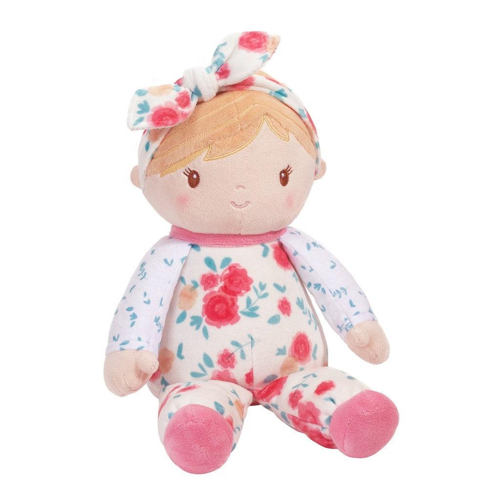 this image shows a smiling plush baby with flower pajama and a flower bow