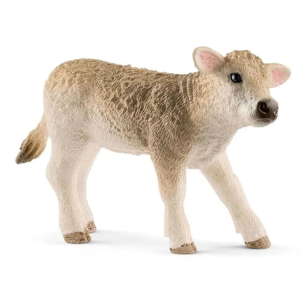 Close up of the young cow figure. It is a light tan/cream color.