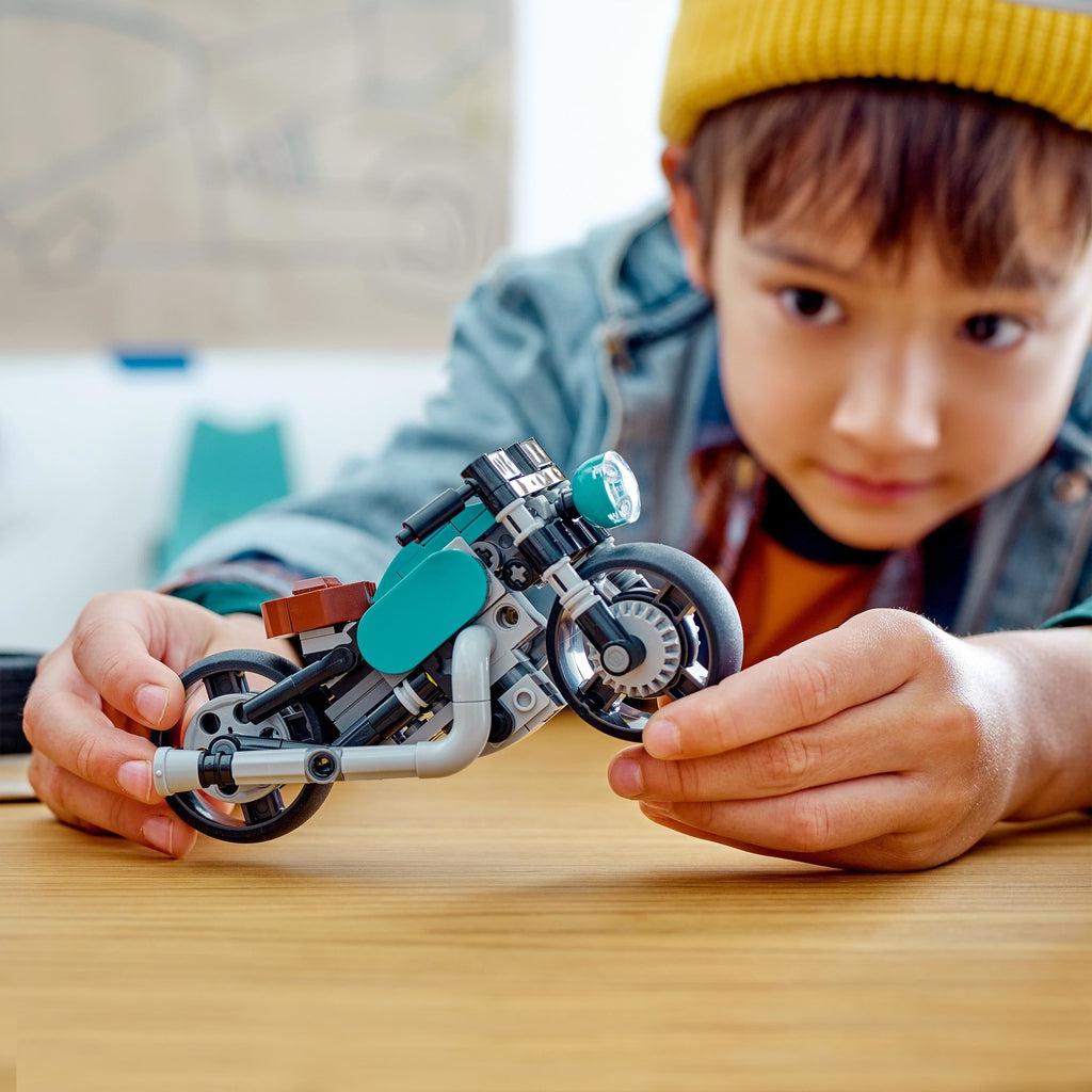 Scene of kid playing with the built LEGO motorcycle.