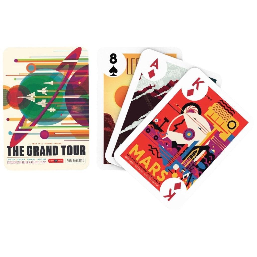Image of the back of the deck of cards. On it is a picture of five rocket ships zooming past different brightly colored planets. 