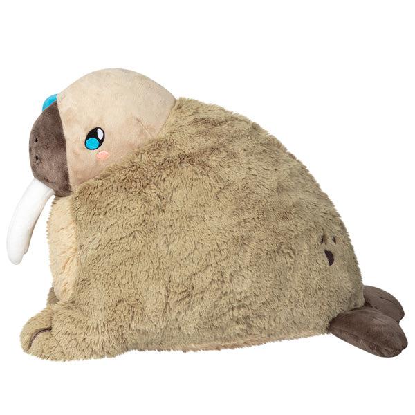 Side view of the plush. Shows that the face is the largest part of the plush and the tail is the smallest.