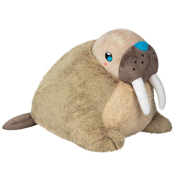 Image of the Walrus squishable. It is a tan plush with long white tusks.