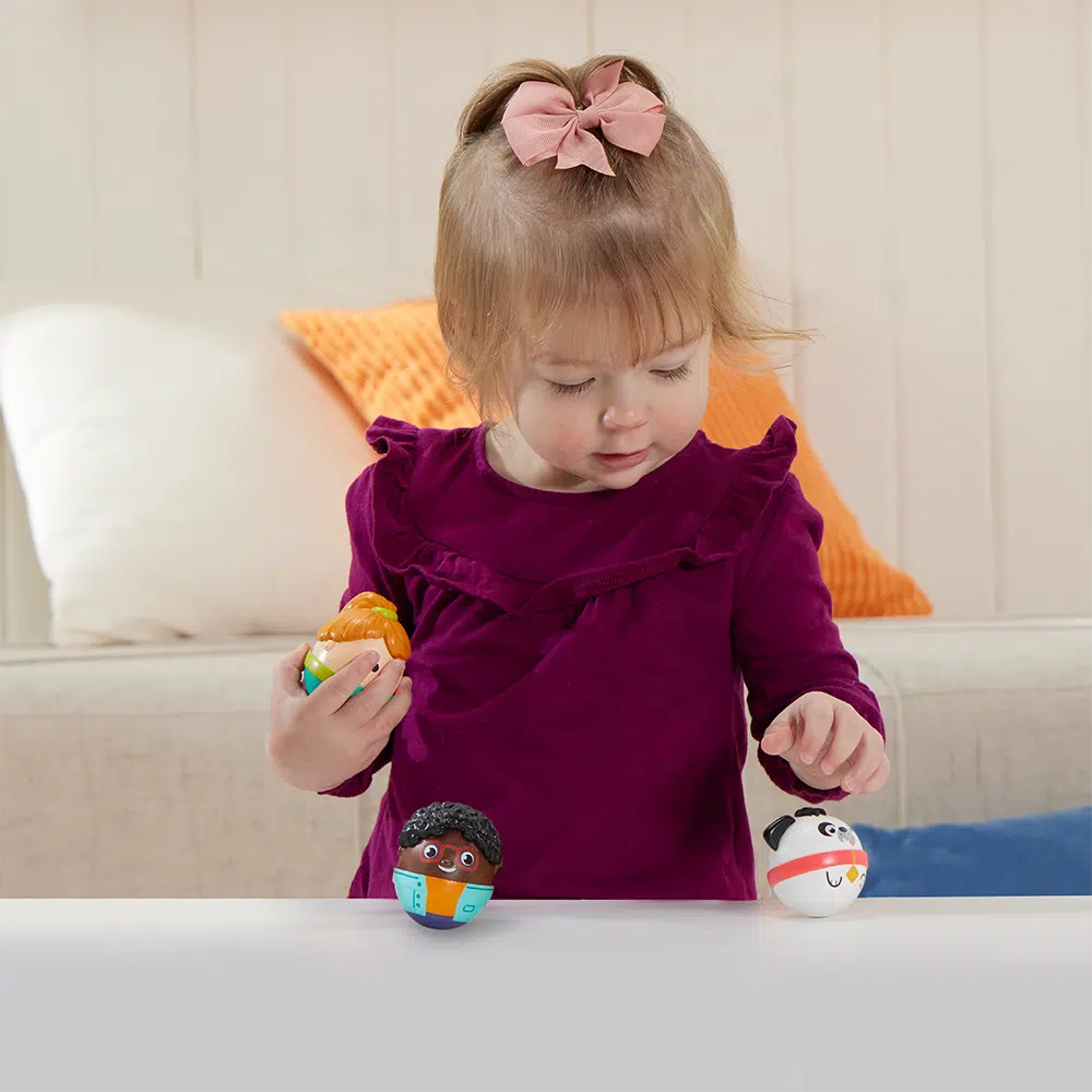 this image shows a girl playing with the three weebles best friends