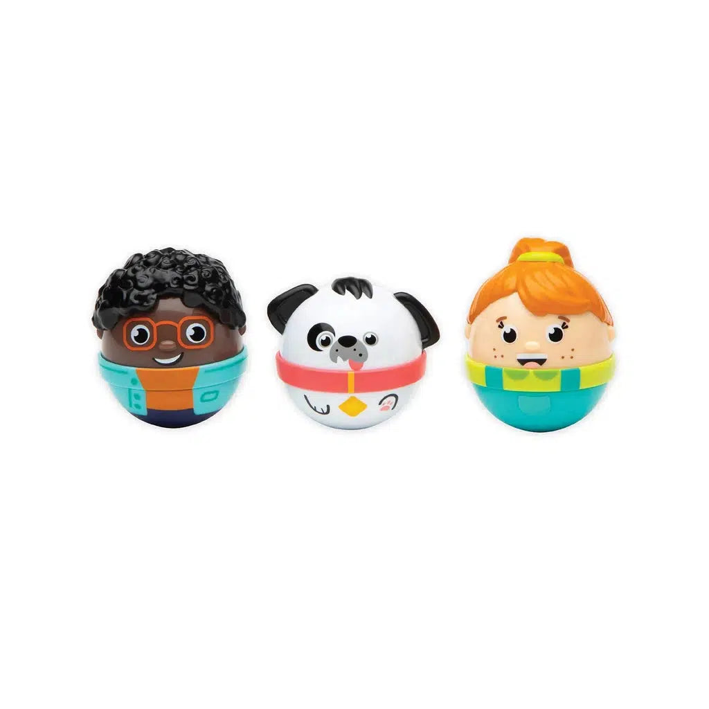 this image shows three weebles. there is a boy, girl, and a dog, the boy has glasses, curly black hair, and a orange and blue shirt combo. the dog is white with black spots and the girl has red har and a green shirt with overalls.