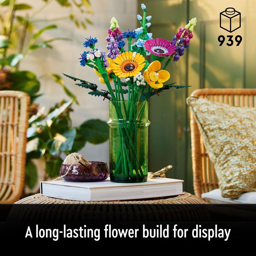 Image of the fully built LEGO flower bouquet on display in a glass vase on a side table. Number of Pieces: 939 Caption: A long-lasting flower build for display