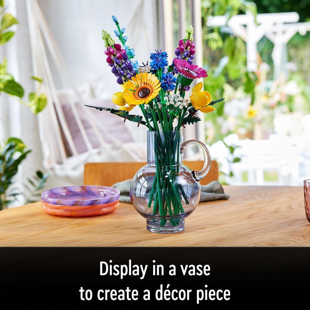 Image of the LEGO flower bouquet in a glass vase on a kitchen table. Caption: Display in a vase to create a decor piece
