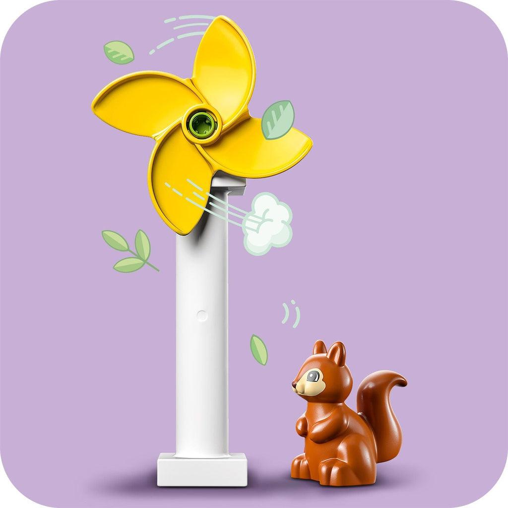 squirrel figure standing next to just the turbine, wind and leaves graphics imply motion of the turbine