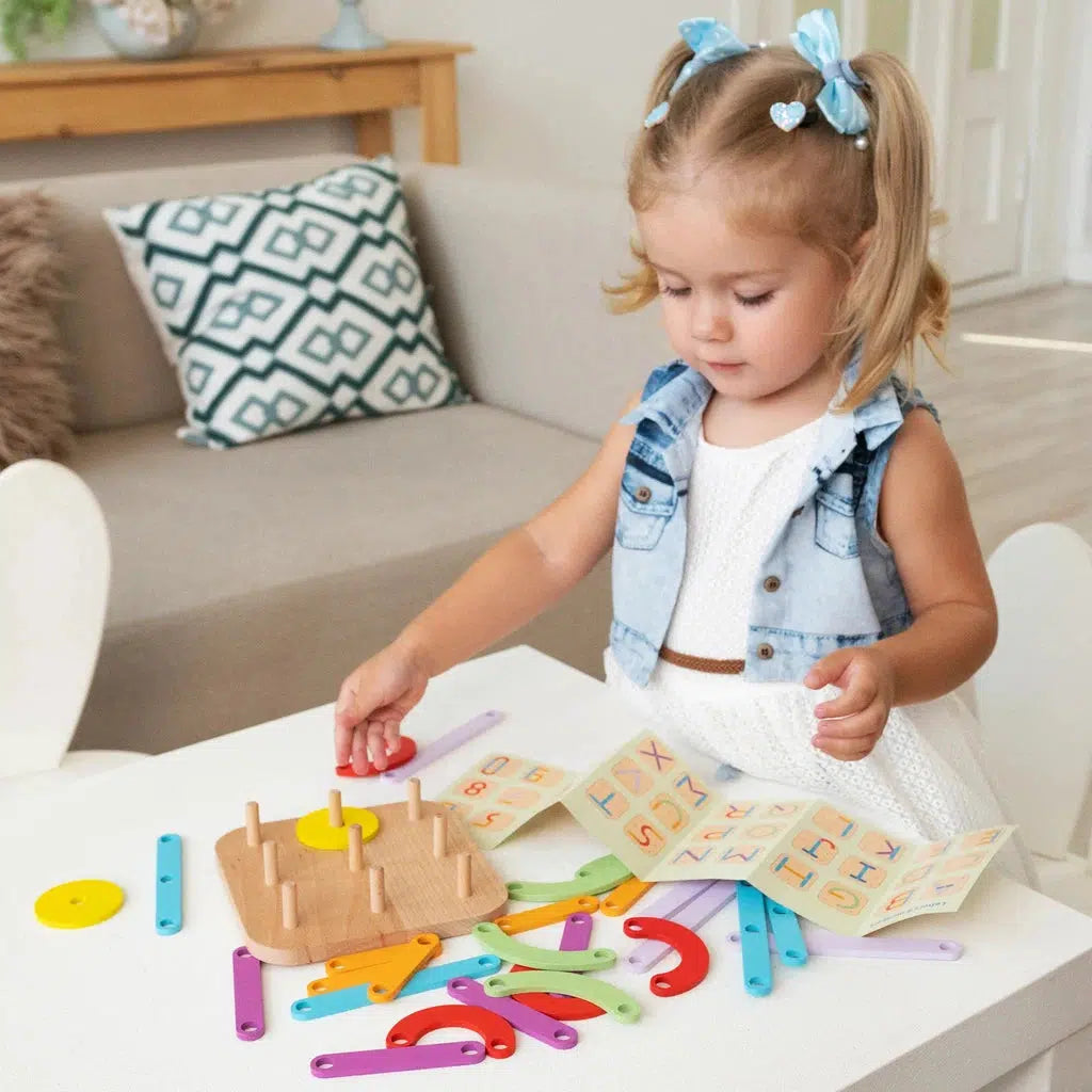a child is playing with the wooden stacking blocks