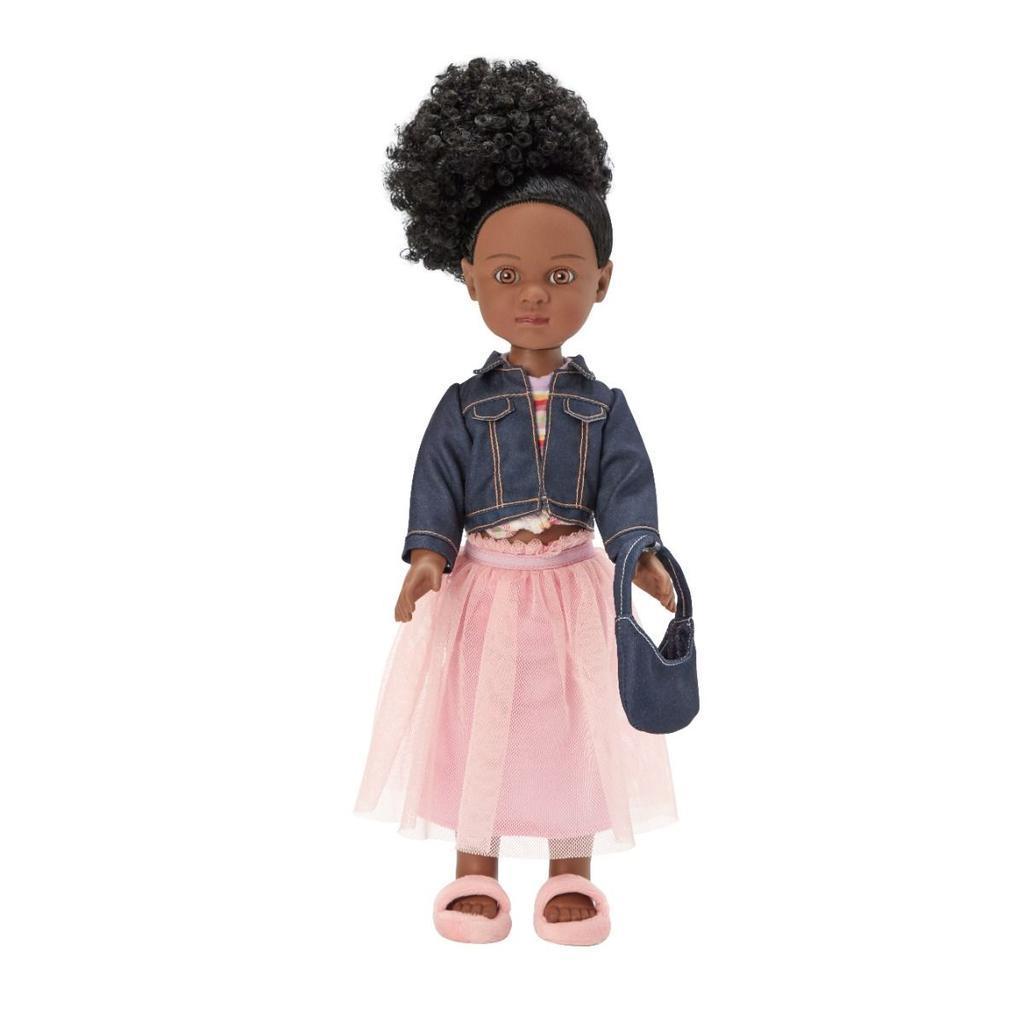 A doll with curly black hair in a high puff, wearing a denim jacket, pink tulle skirt, pink sandals, and holding a small denim purse.